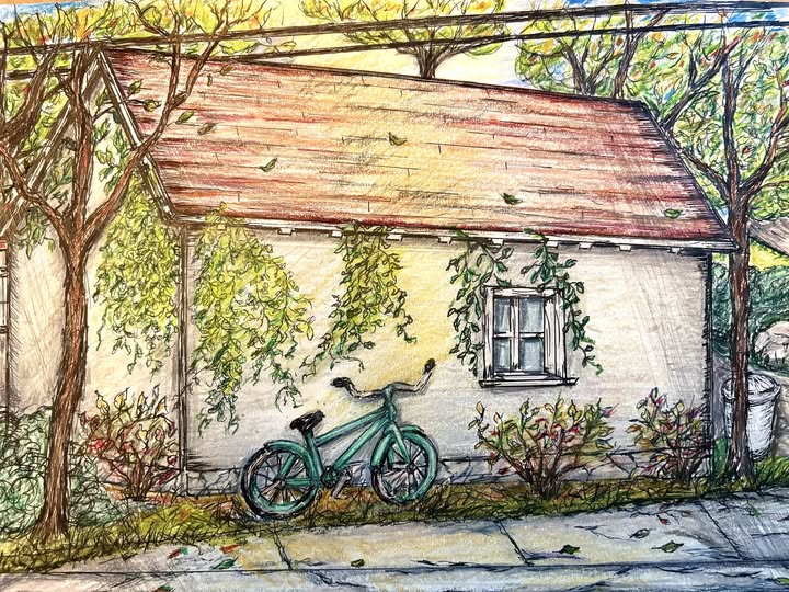 A teal bicycle leans against a charming, vine-covered house with a red roof, surrounded by trees, capturing a peaceful neighborhood scene.